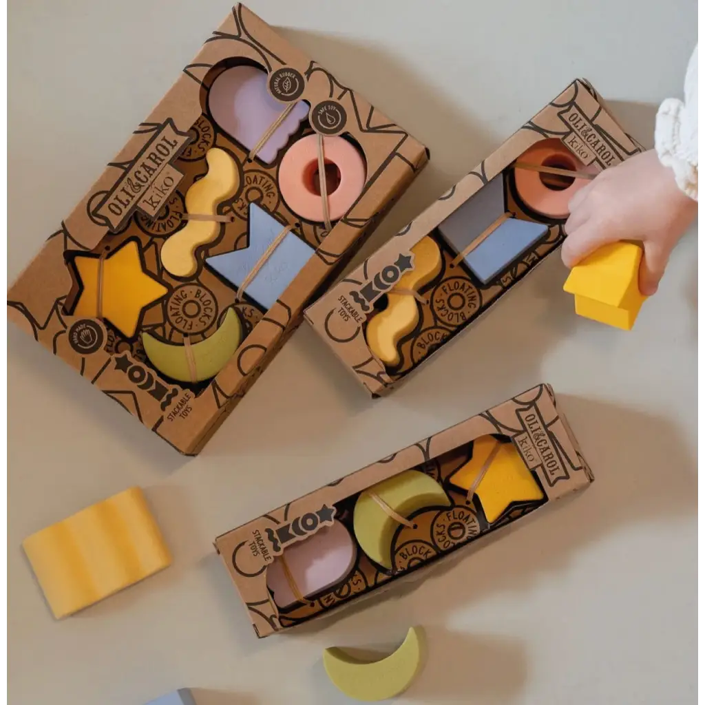 Cardboard boxes of colorful wooden toy blocks shaped like geometric figures in natural rubber