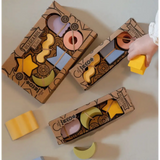 Cardboard boxes of colorful wooden toy blocks shaped like geometric figures in natural rubber