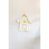 Child’s T-shirt with a star design, featuring rosy cheeks and elegant blue script