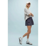 Woman in gray t-shirt and dark blue Layla Linen Shorts with side slits, stylish womens clothes