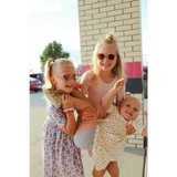 Three happy kids in summer dresses enjoying fun moments in a Lemon Shake Up Twirl Dress