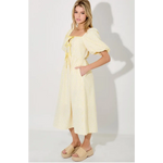 Woman wearing Lemon Meadow Gingham Midi Dress in a yellow gingham midi dress style