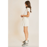 Woman in white T-shirt and skirt wearing Libby Athletic Mesh Romper showcasing lightweight athletic mesh
