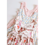 Three sleeveless Libby Twirl Dresses in pink and white floral patterns for fun days out