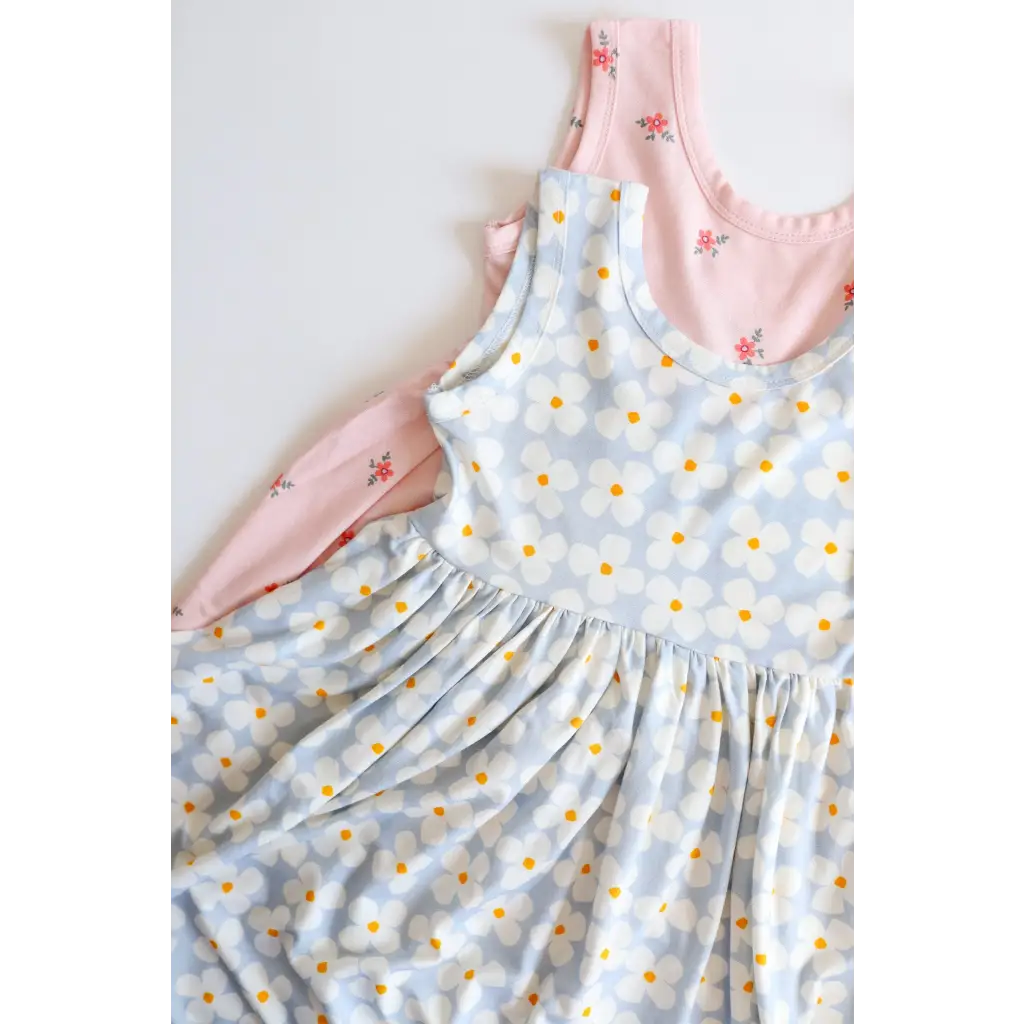 Light blue floral Libby Twirl Dress with pink dress peeking behind it