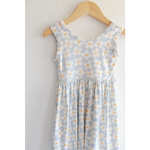 Light blue Libby Twirl Dress with daisy print hanging on wooden hanger for everyday fun
