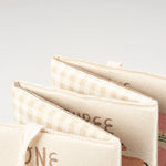 Three canvas pouches with gingham accents on the Little Farm Soft Book for kids