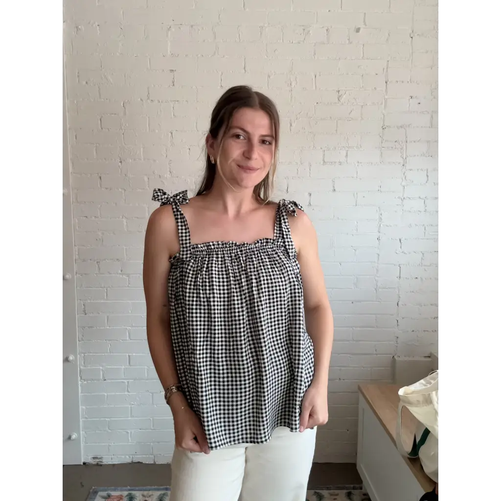 Woman wearing Lucy Gingham Linen Blend Tie Shoulder Tank Top with black and white gingham