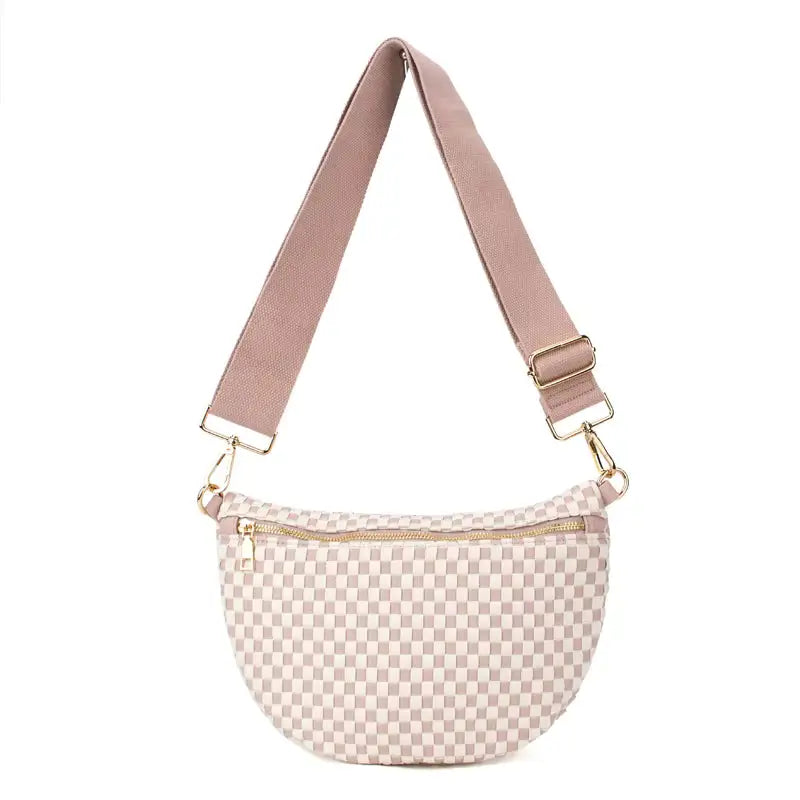 Pink checkered Lucy Woven Sling Bag made from vegan leather with an adjustable wide strap