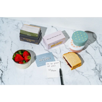 Colorful lunch box notes and tasty treats on marble surface for happy kids’ lunches