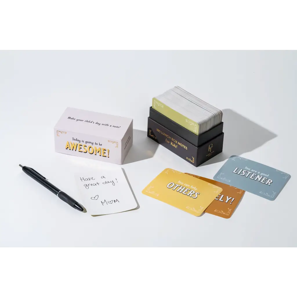 Stack of motivational lunch box notes with a pen and notepad for brightening days