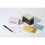 Stack of motivational lunch box notes with a pen and notepad for brightening days