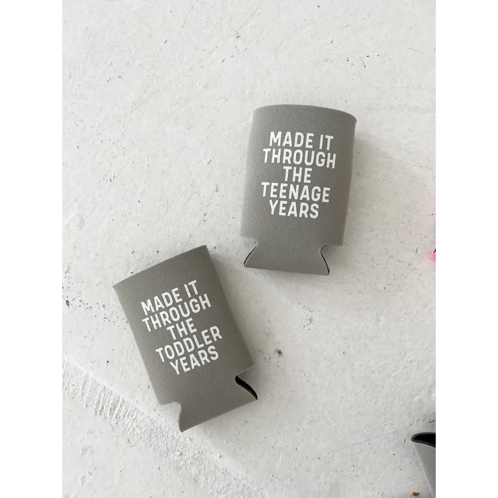 Two gray koozies with funny sayings about surviving the toddler years from Polished Prints