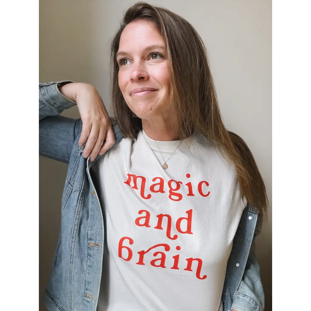 Woman wearing a magic and brain t-shirt featuring Kate Baer’s moon song design, final sale