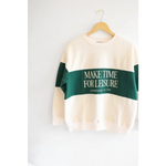 Cream sweatshirt with green stripe saying MAKE TIME FOR LEISURE, perfect for relaxing vibes
