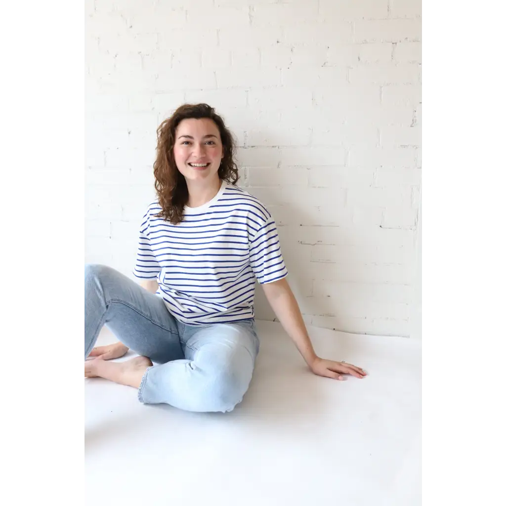 Woman in striped shirt and jeans showcasing Mary Striped Short Sleeve, stylish womens clothes