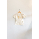 Child’s cream-colored T-shirt with hand-drawn pasta illustrations and classic crew neck