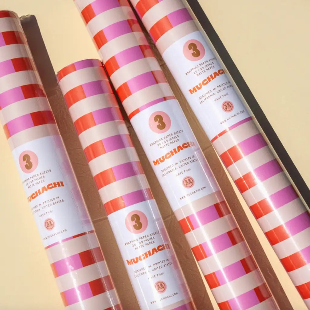 Striped pink and red wrapping paper rolls in the Muchachi Merengue Gift Set
