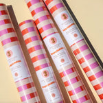 Striped pink and red wrapping paper rolls in the Muchachi Merengue Gift Set