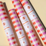 Striped pink and red wrapping paper rolls in the Muchachi Merengue Gift Set