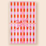 Gingham-patterned notebook with pink ribbon from Muchachi Merengue Modern Wrapping Paper