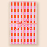 Gingham-patterned notebook with pink ribbon from Muchachi Merengue Modern Wrapping Paper