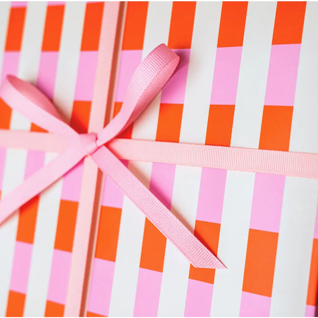 Pink ribbon bow on striped pink and orange Muchachi Merengue modern wrapping paper