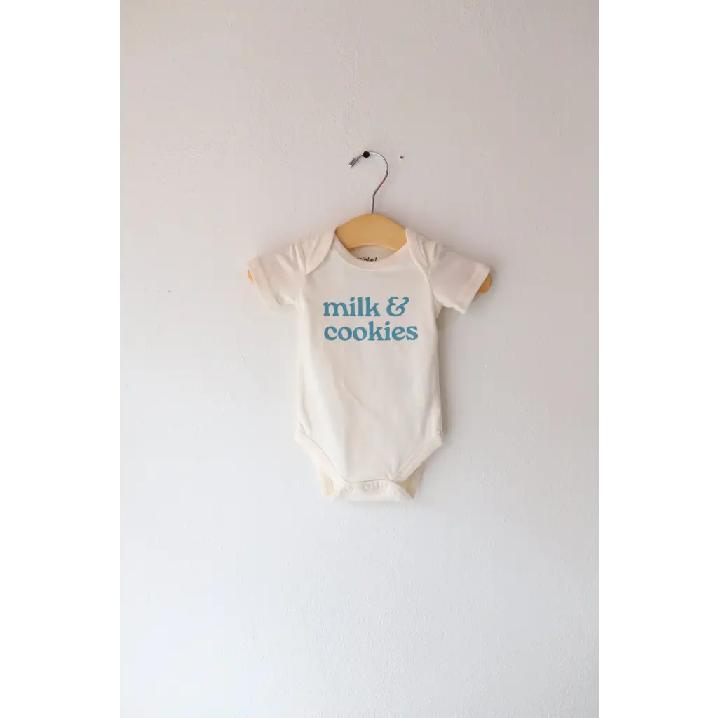 Cream-colored gender neutral onesie in organic cotton with milk and cookies design
