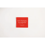 Red coaster featuring cursive text, perfect for a Playful Judgement Waterproof Sticker vibe