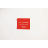 Red coaster featuring cursive text, perfect for a Playful Judgement Waterproof Sticker vibe