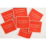 Red coasters with white text scattered, showcasing the Playful Judgement Waterproof Sticker