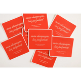 Red coasters with white text scattered, showcasing the Playful Judgement Waterproof Sticker