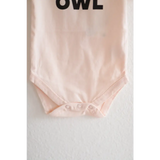 Light pink organic cotton night owl onesie for baby with OWL text at the top