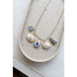 Gold chain necklace with clay charms like shells, sailboat, fish, and good luck symbols