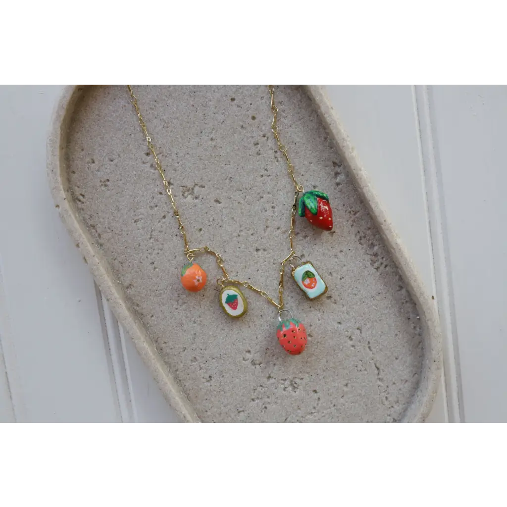 Gold chain necklace with five fruity clay charms, perfect seaside charm necklace style