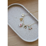Gold seaside charm necklace with clay charms like a heart, horse, card, horseshoe, and dress