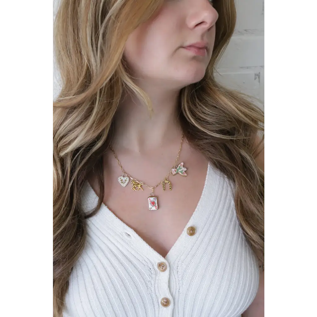 Gold-toned seaside charm necklace with colorful whimsical clay charms for good luck