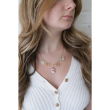 Gold-toned seaside charm necklace with colorful whimsical clay charms for good luck