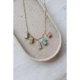 Gold chain necklace with five pastel clay seaside charms for the No. 3 Homebody look