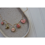 Gold chain necklace with colorful clay seaside charms on Pretty in Pink product page