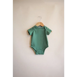 Sage green short-sleeved baby bodysuit on a hanger, made from organic cotton in Dark Ivy