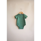Sage green short-sleeved baby bodysuit on a hanger, made from organic cotton in Dark Ivy