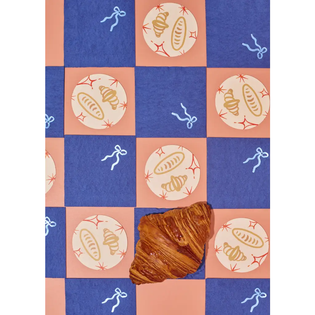 Flaky golden-brown croissant on Oui Croissants Coasters with stylish prints for moms