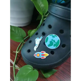Black Croc shoe with 3-piece outer space charm set featuring astronaut, Earth, and rocket