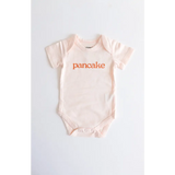 Light pink pancake organic cotton onesie for cozy cuties with fun orange text