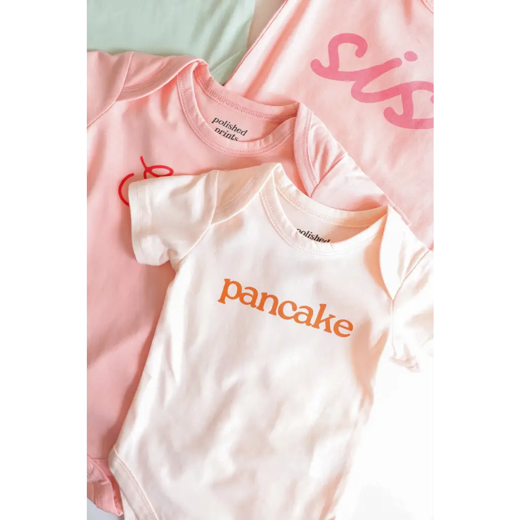 Cute pink and white baby onesies made of organic cotton for cozy cuties
