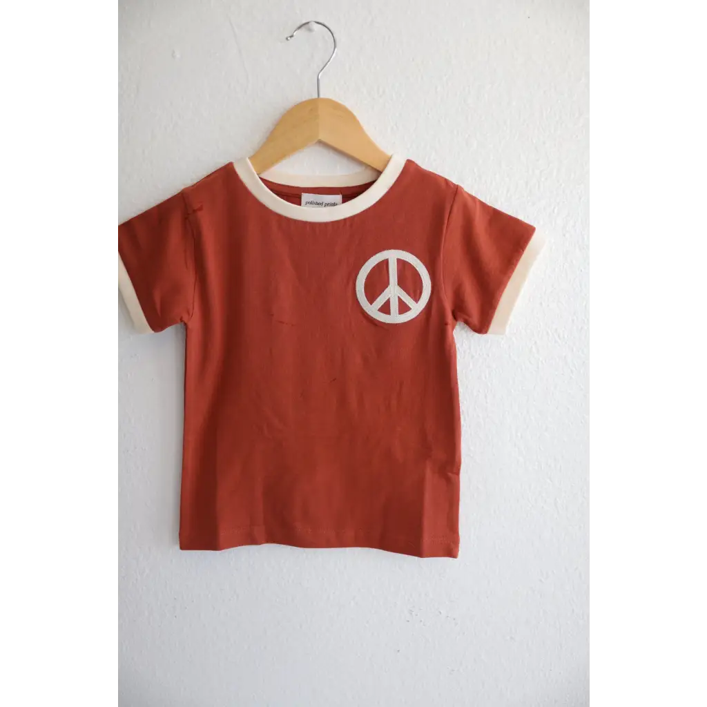 Rust Peace Embroidered Ringer Tee for Kids featuring a white peace symbol design