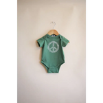 Green baby onesie with peace symbol design from the Peace Floral Organic Cotton collection