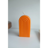 Orange arch-shaped candle with grooves for a fun Petite Rainbow Candle vibe