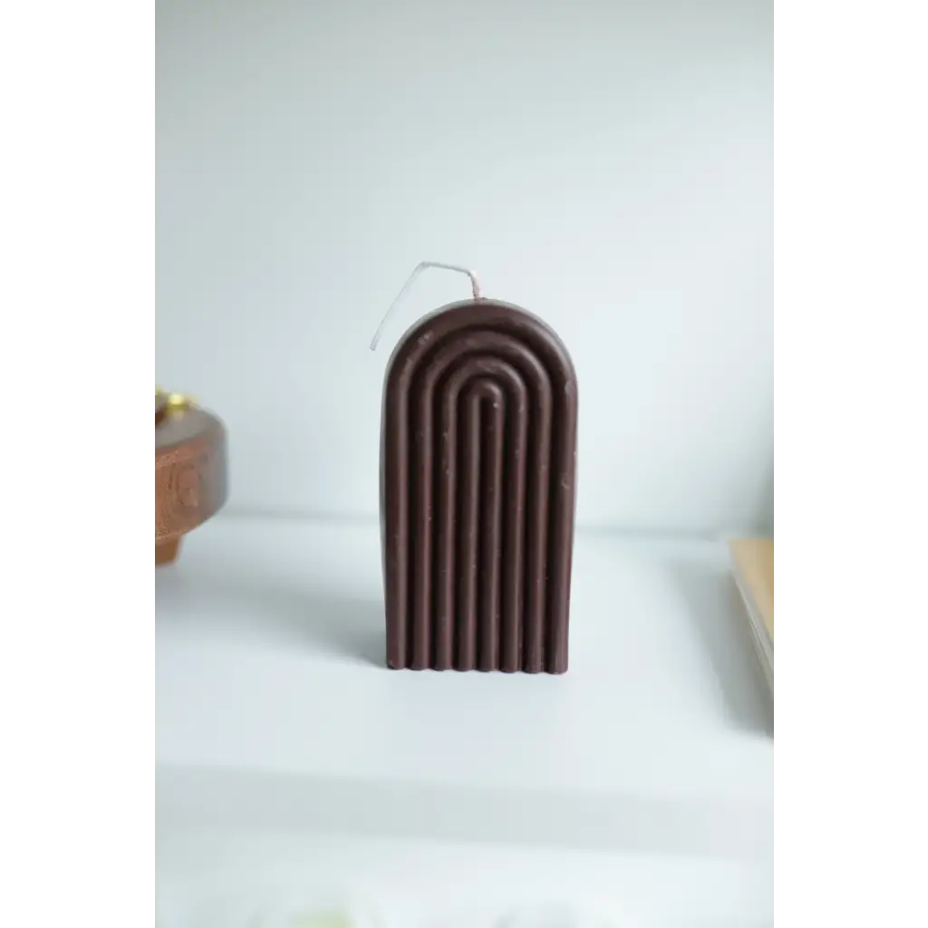 Brown arch-shaped candle with ridged patterns for a cute Petite Rainbow Candle vibe